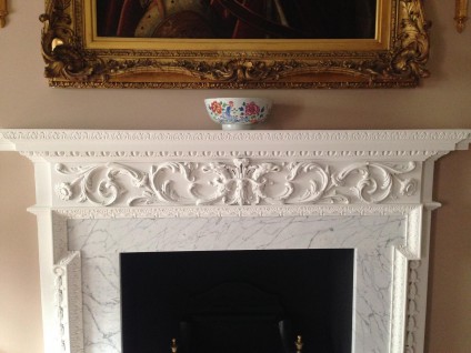 An English handcarved wooden fireplace surround in Georgian Style circa 1920